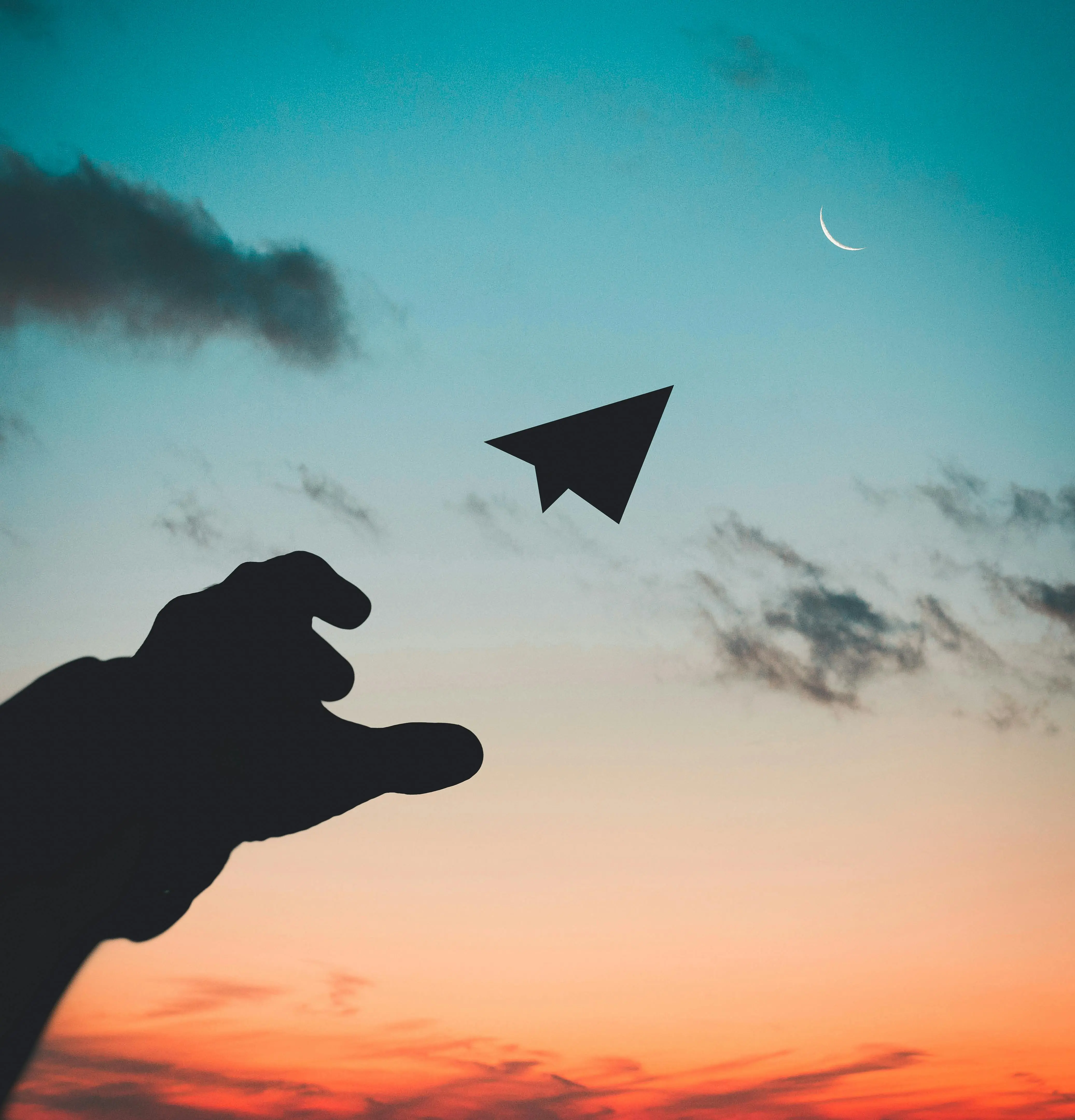 A hand throwing a paper plane